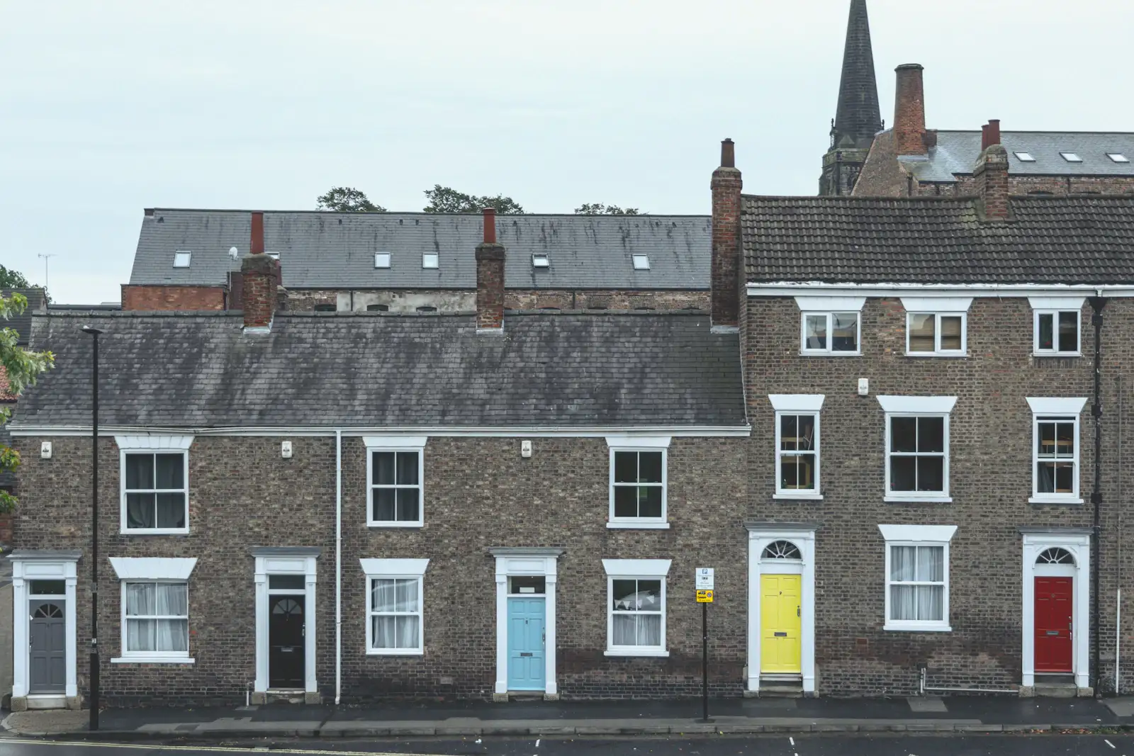 Georgian brick terraced houses with brightly painted front doors